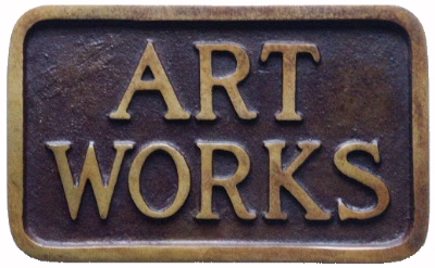 This is a picture of a rectangular brozne plaque with the words ART WORKS in relief on the top